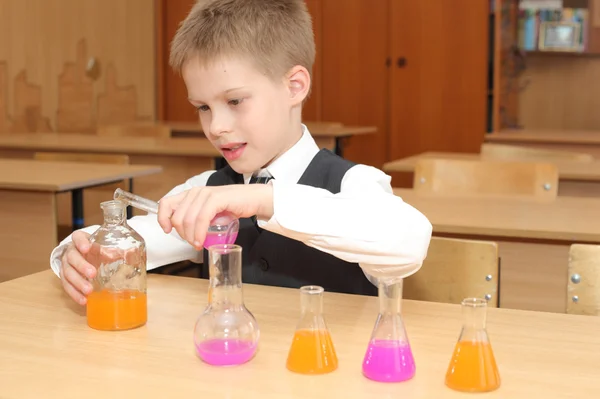 Junge mit den rosafarbenen Chemikalienröhrchen — Stockfoto