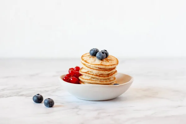 Homemade buckwheat flour free gluten pancakes decorated with blueberry and redcurrant — Stock Photo, Image