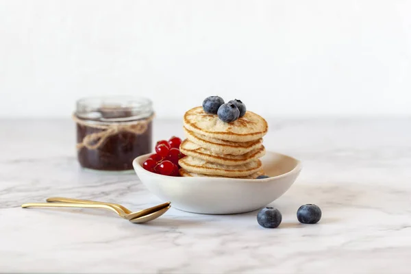 Homemade buckwheat flour gluten free pancakes decorated with blueberry and redcurrant — Stock Photo, Image