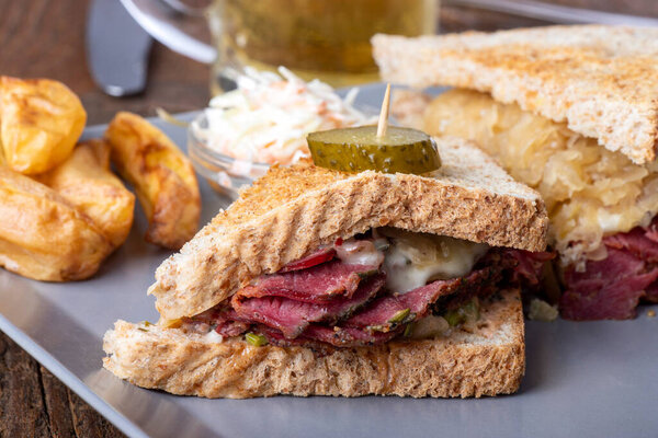 reuben sandwich on a plate with fries