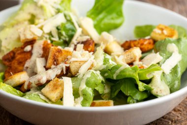 caesar salad on dark wood