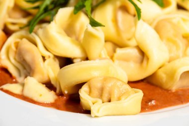 overview of tortellini pasta on a white plate