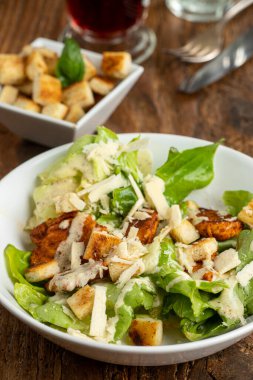 caesar salad on dark wood
