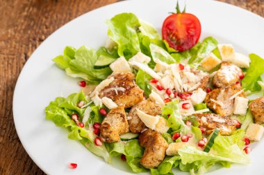 caesar salad on dark wood