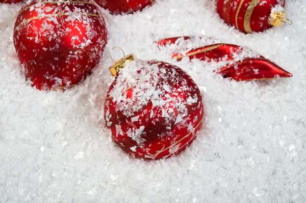An image of christmas ornaments in snow — Stock Photo, Image