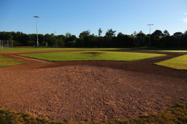 A wide angle view of baseball field shot early in the morning. clipart