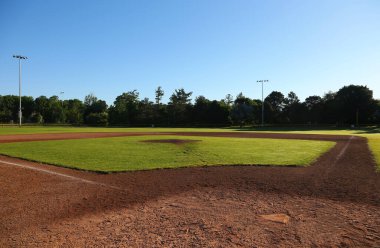 A wide angle view of baseball field shot early in the morning. clipart
