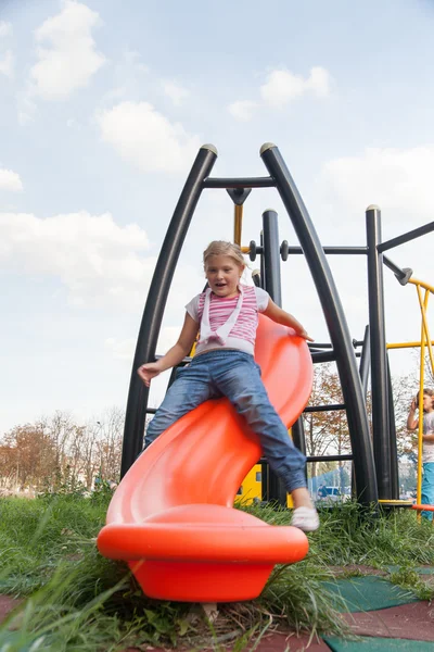 Girl riding rides on a child playground — Stock Photo, Image