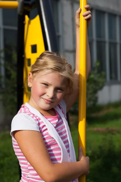 Girl riding rides on a child playground — Stock Photo, Image