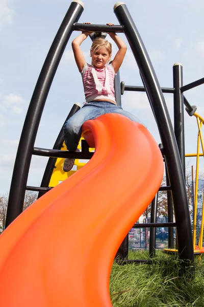 Girl riding rides on a child playground — Stock Photo, Image