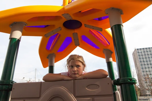 Cavalcate ragazza su un parco giochi per bambini — Foto Stock