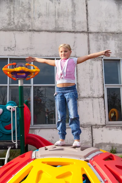 Girl riding rides on a child playground — Stock Photo, Image