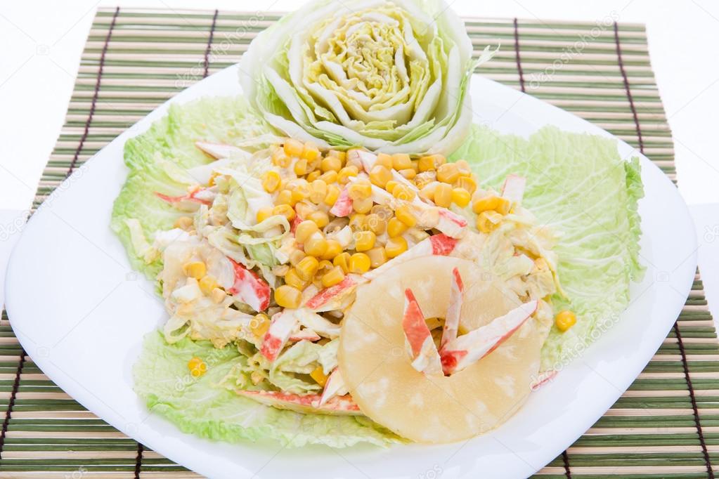 Mixed salad with white dressing served pretty on a large plate