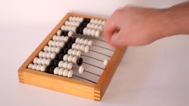 Male hand using the abacus to calculate basic algebra adding and subtracting — Stock Video