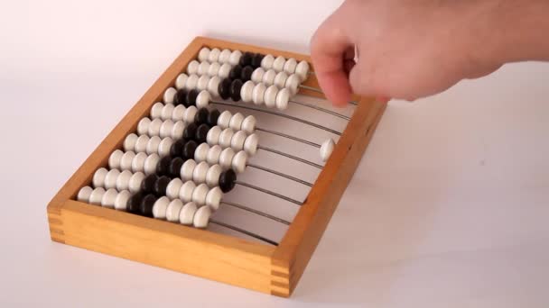 Male hand using the abacus to calculate basic algebra adding and subtracting — Stock Video