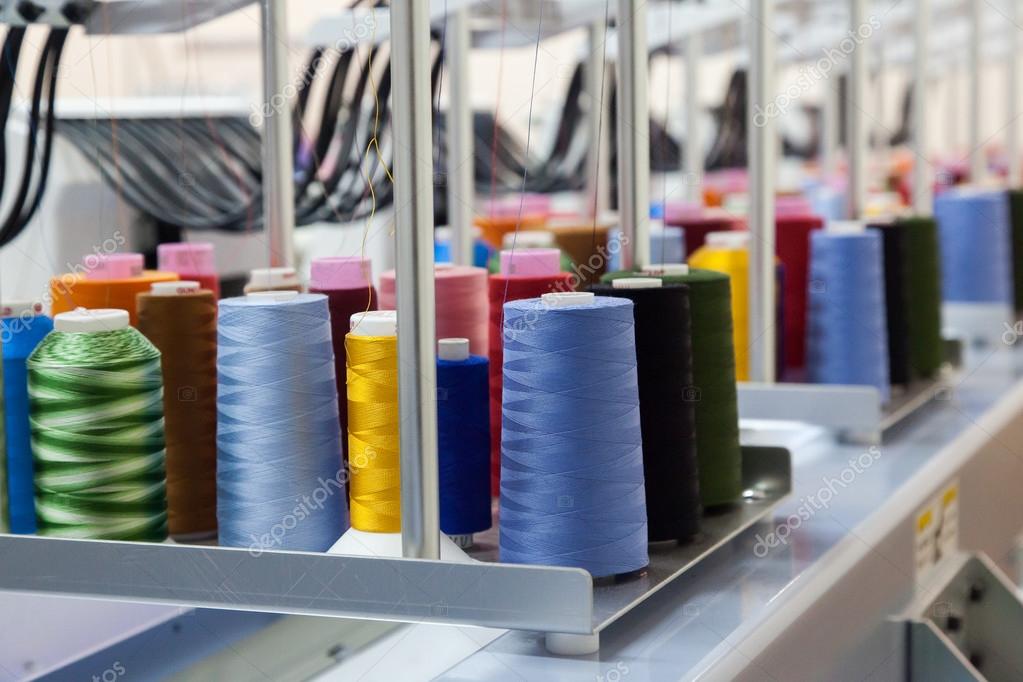 Colorful reels of threads background - interior of industrial textile factory