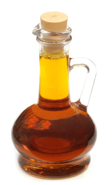 Edible mustard oil in a transparent glass jar — Stock Photo, Image