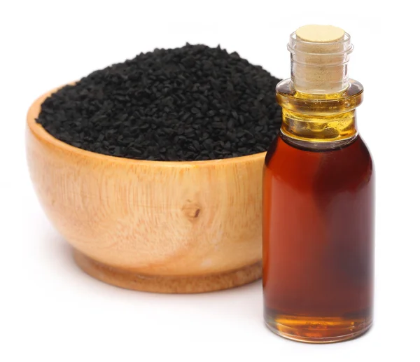 Nigella sativa oder Schwarzkümmel mit ätherischem Öl — Stockfoto