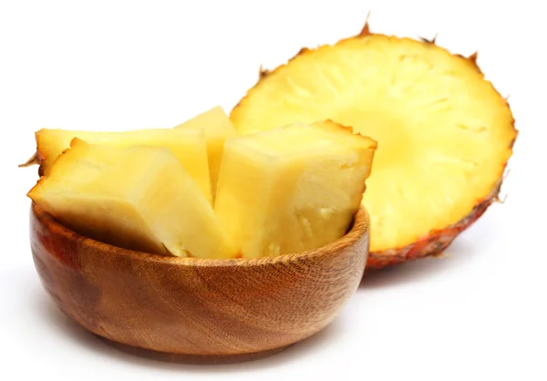 Sliced pineapple on a wooden bowl — Stock Photo, Image