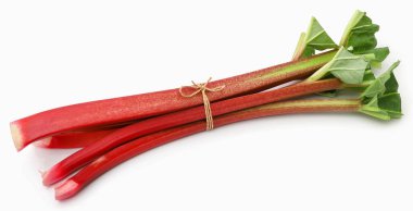 Fresh rhubarb stem and leaves over white background
