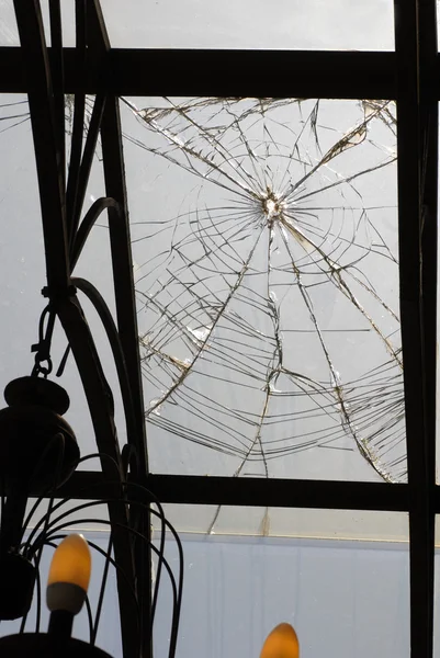 Broken glass on ceiling of porch — Stock Photo, Image