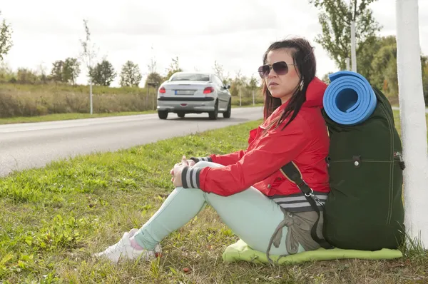 Hitchhiker on the road side — стоковое фото