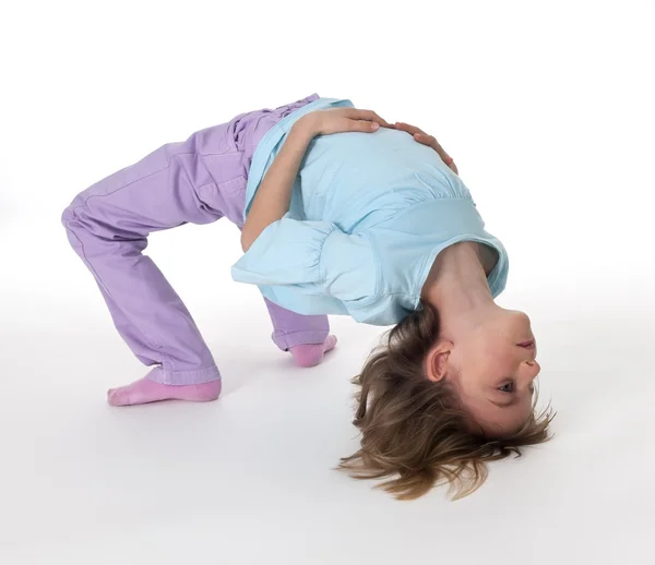 Little girl doing body bridge — Stock Photo, Image