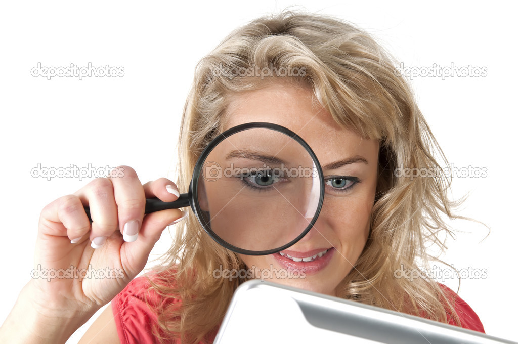 Woman with loupe and tablet computer