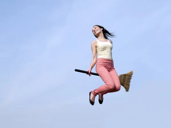 Woman riding broom — Stock Photo, Image