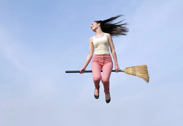 Woman riding broom — Stock Photo, Image