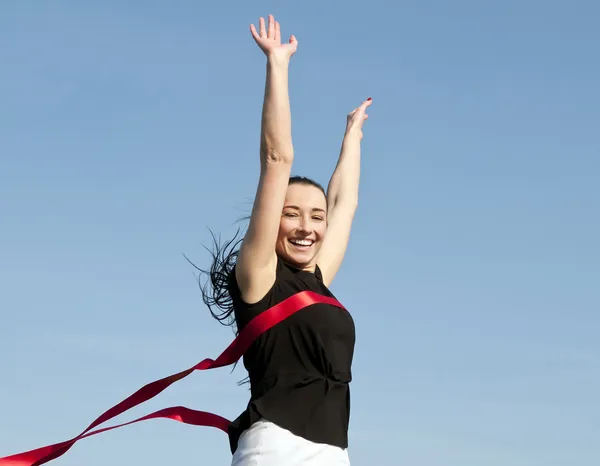 Woman crossong finishing line — Stock Photo, Image