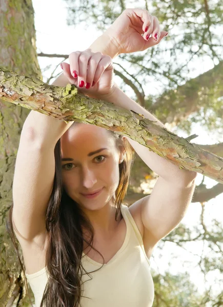 Mujer apoyada en el árbol — Foto de Stock