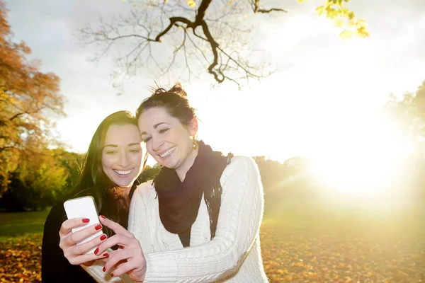 Glückliche Freundinnen mit Smartphone — Stockfoto