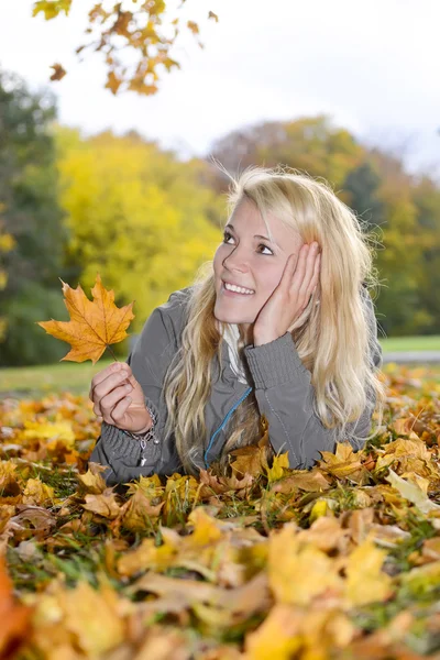 Woman with autumn leave — Stock Photo, Image