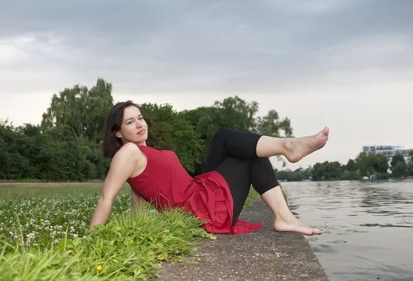 Woman sitting on river — Stock Photo, Image