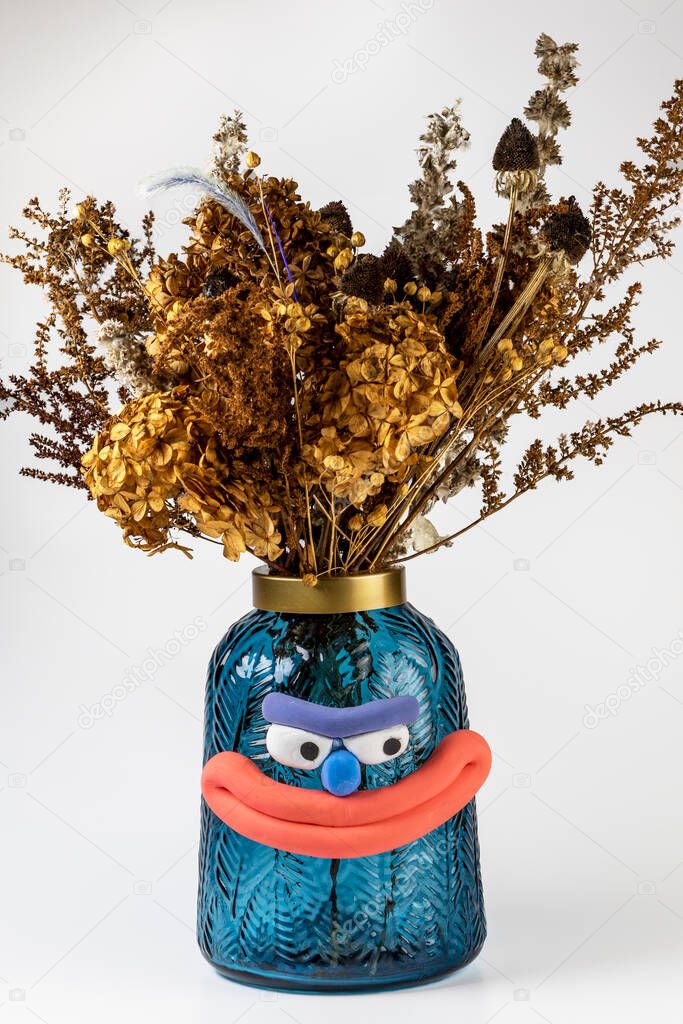 Element of decor. Vase with dried flowers