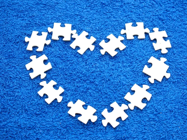 Puzzle on a dark blue fabric — Stock Photo, Image