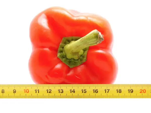 Pepper and ruler on a white background — Stock Photo, Image