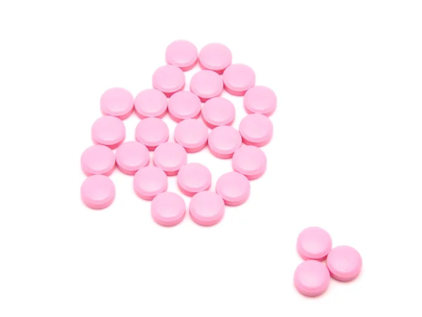 Pink tablets on a white background — Stock Photo, Image