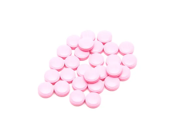 Różowe tabletki na białym tle — Zdjęcie stockowe