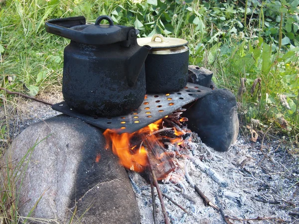 Teekanne und Wasserkocher auf dem Feuer im Sommer — Stockfoto