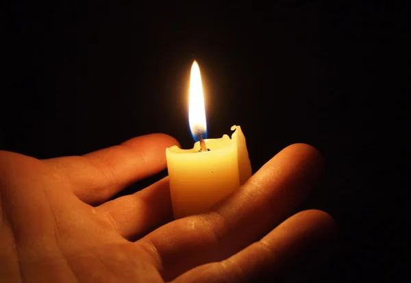 Hand with candle Royalty Free Stock Images