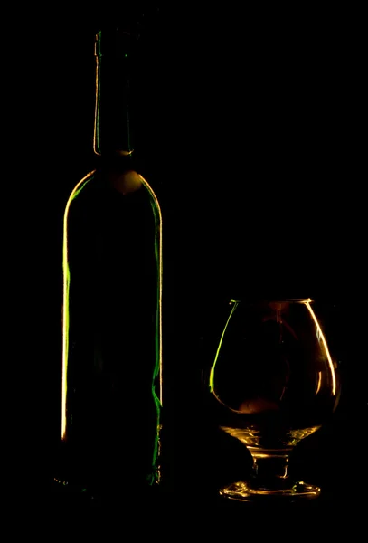 Bottle and glass on a black background — Stock Photo, Image