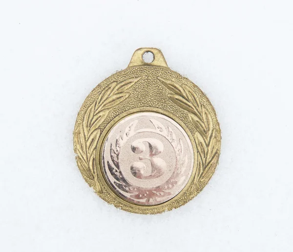 Medal on a snow — Stock Photo, Image