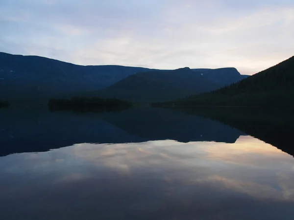 Sunset on the lake in the mountains Stock Image