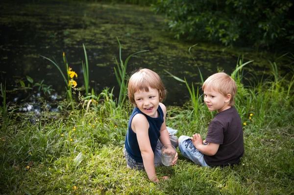 Two cheerful boy on a pond Royalty Free Stock Photos