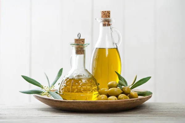 Olive Oil Bottles Green Olives Fruit Olive Branch Wooden Table — Zdjęcie stockowe