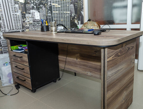 high-quality expensive natural wood office desk with a large top and drawers for office supplies