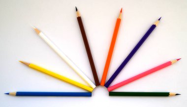 multicolored pencils for drawing and art on a white background
