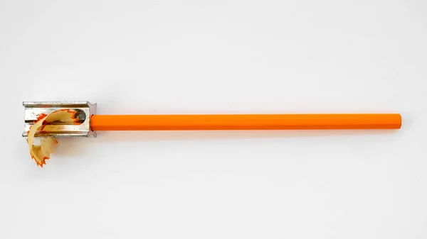 orange pencil with sharpener on white background